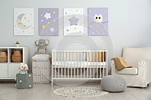 Baby room with crib and cute posters on wall