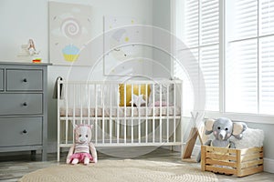 Baby room with cute posters and crib