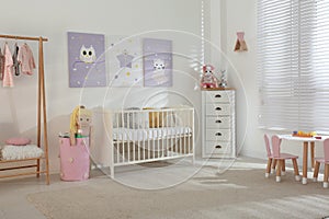 Baby room with cute posters and crib