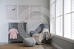 Baby room with cute posters and rocking chair