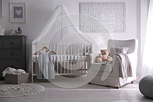 Baby room interior with crib and armchair