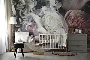 Baby room interior with crib and floral wallpaper