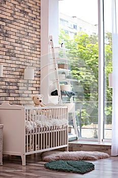 Baby room interior with crib near wall