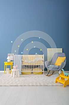 Baby room interior with crib and rocking chair