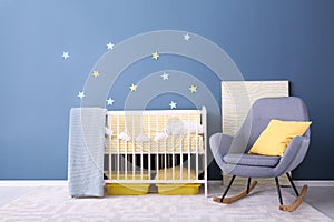 Baby room interior with crib and rocking chair