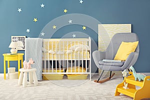 Baby room interior with crib and rocking chair