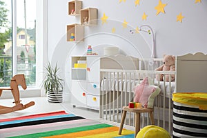 Baby room interior with crib and toys