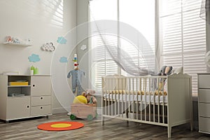 Baby room interior with crib and toys