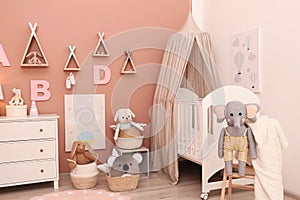 Baby room interior with furniture and comfortable crib