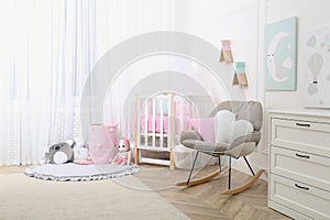 Baby room interior with toys and stylish furniture