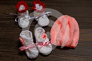 Baby's bootee and cap on wooden