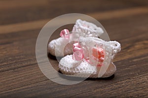 Baby's bootee on wooden