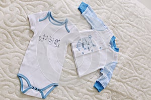 Baby`s clothes on white background. Waiting for baby. Clothes for newborn on a pastel background.