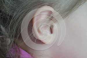 Baby`s ear close-up macro. Human anatomy. Symbol of hearing