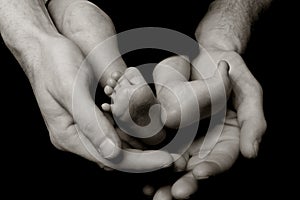 Baby`s feet (in daddy`s hands) photo