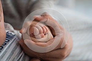 Baby`s finger with parent together hold hand