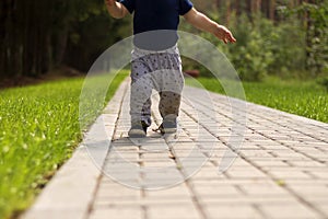 Baby`s first steps.The first independent steps. Running toddler in the park