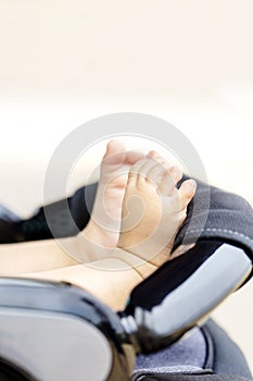 Baby`s foot and buggy and copy space outdoors