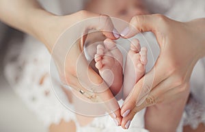 Baby's foot in mother hands.