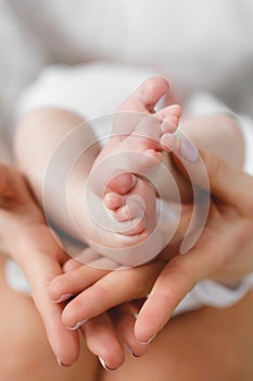 Baby's foot in mother hands.