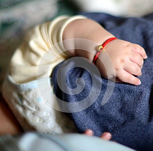 Baby`s hand and golden ornament