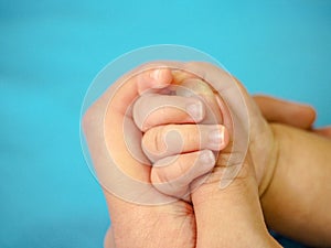 Baby`s hand gripping for mothers finger