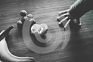 Baby s hand manipulating different fruits on a wooden table