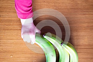 Baby s hand manipulating different fruits on a wooden table