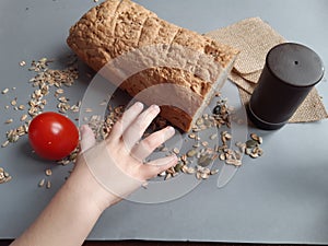 baby's hand reaching for bread