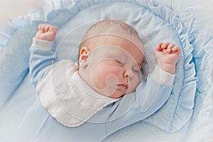 Baby`s restful sleep. Newborn baby in a wooden crib. The baby sleeps in the bedside cradle.