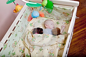 Baby`s restful sleep. Newborn baby in a wooden crib. The baby sleeps in the bedside cradle. Safe living together in a bedside cot