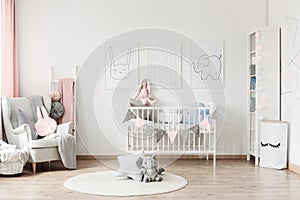 Baby`s room with grey armchair