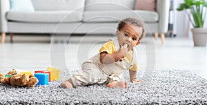 Baby Safety. Adorable Little Black Boy Biting Wine Cork Found On Floor