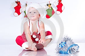 Baby Santa Claus with garlands of Christmas bootee