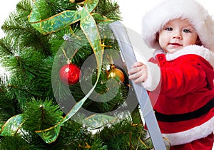 Baby in Santa costume on a step ladde