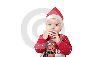 Baby in Santa hat playing with Christmas balls, isolated on white