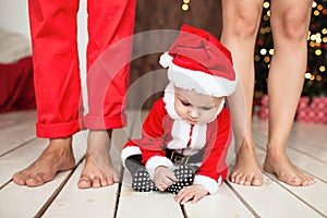 Baby in santa suit with family indoor