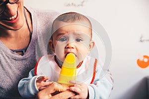 Baby savoring an orange ice cream