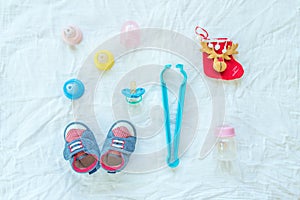 Baby set of item and accessories on white fabric background