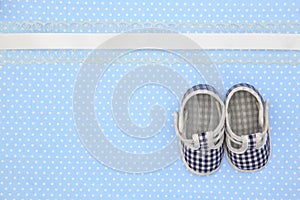 Baby shoes on blue polka