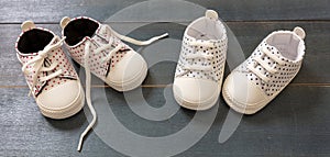 Baby shoes on blue wooden floor color background