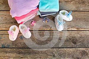 Baby shoes, clothing and pacifiers pink and blue