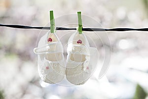 Baby shoes hanging on the clothesline