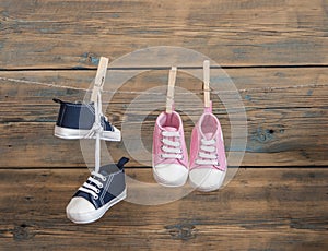 Baby shoes hanging on the clothesline.