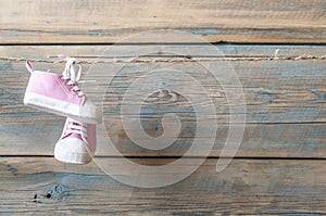 Baby shoes hanging on the clothesline.