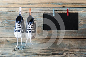 Baby shoes hanging on the clothesline.