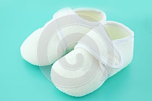 Baby shoes on light blue