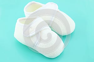 Baby shoes on light blue