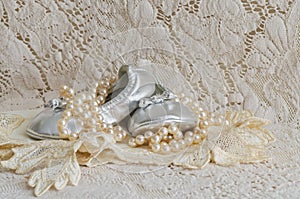Baby Shoes and Pearls on Lace Handkerchief