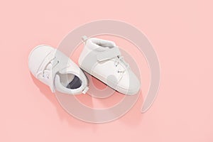 Baby shoes on pink background